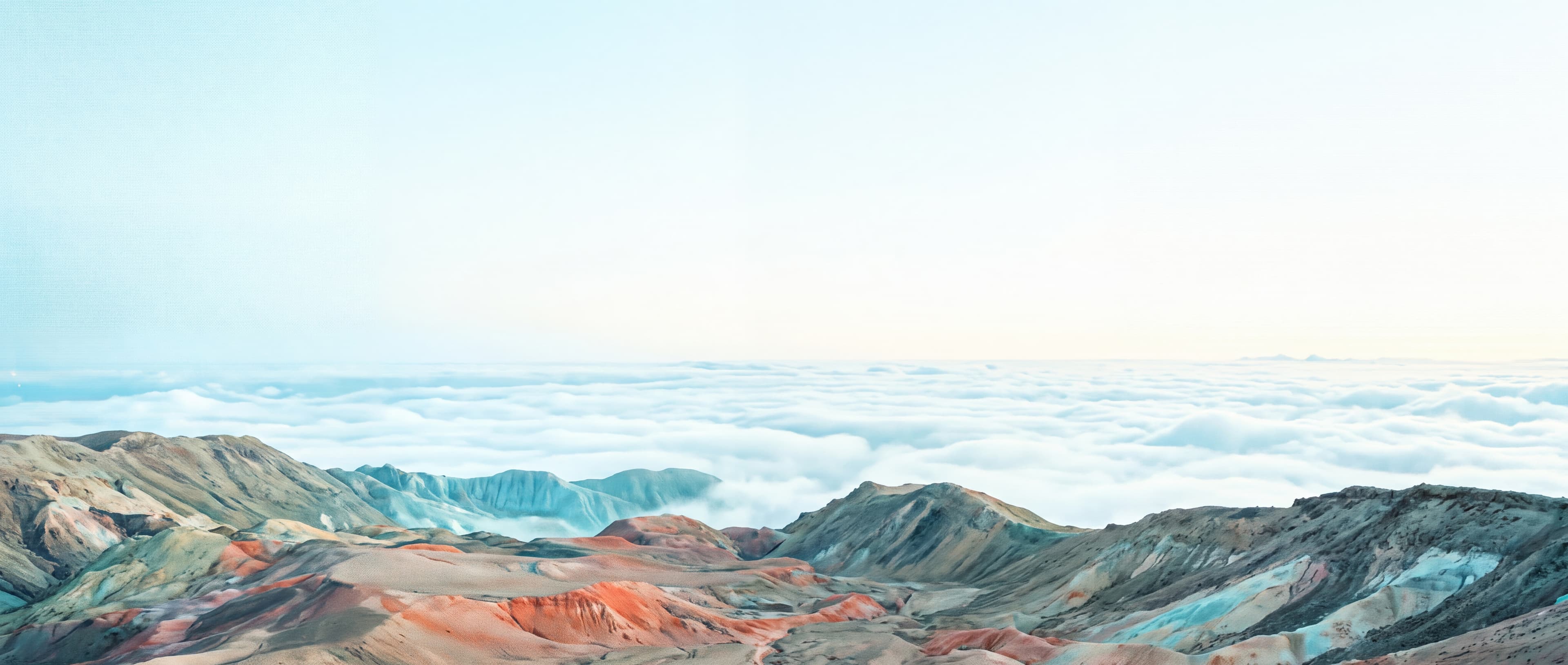A mineral valley opening above a field of clouds
